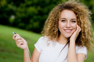 Girl listening to refurbished headphones