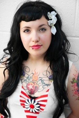 Beautiful brunette wearing body jewelry in her two facial piercings
