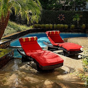 Chaise lounges next to a backyard pool