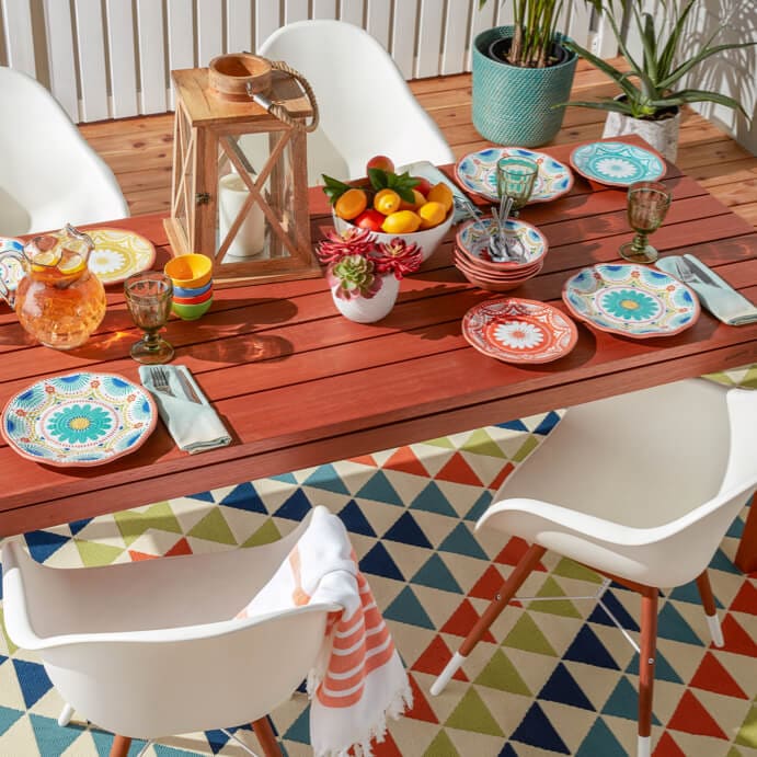 Beautifully decorated outdoor dining space with color kitchen decor and patterned outdoor area rug only at Overstock.com