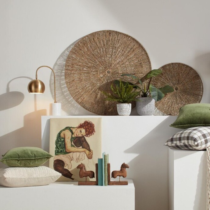 Natural home decor with throw pillows, planters, and lamps, with a green and beige color scheme available online at Overstock